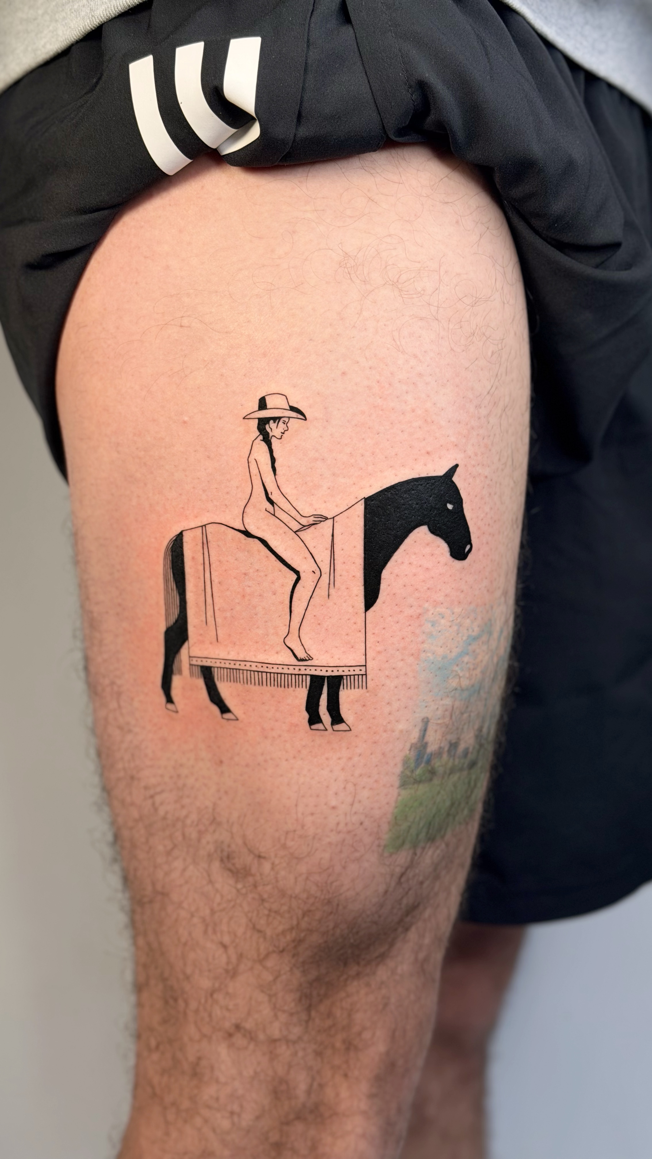 Blackwork thigh tattoo of a figure on a horse with a cactus-pattern blanket — illustrative line work and graphic Mexican folk-art composition by Jane Again Tattoo, Mexico City.