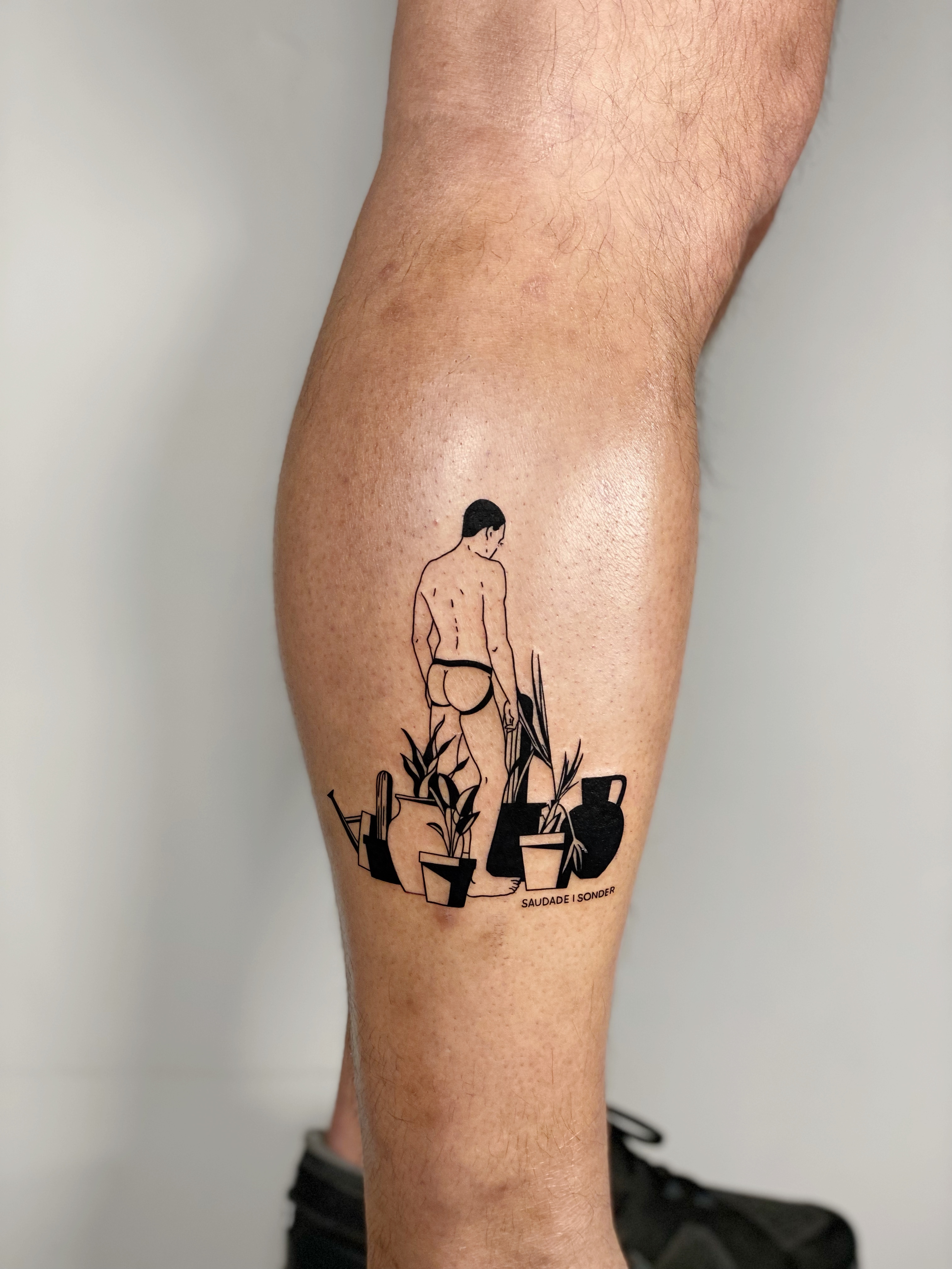 Blackwork queer gay tattoo of a male nude back figure with potted plants on the calf — illustrative line work and graphic figural composition by Jane Again Tattoo, Mexico City.